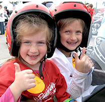 Star Ava (left) and her sister Ella are thrilled to ride in Houston.